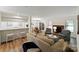 Open-concept living room featuring a fireplace, kitchen with bar seating, and dining area at 407 Sweetgum Dr # B, Fort Mill, SC 29715