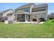 Well-maintained backyard with a screened-in porch, outdoor seating, and a built-in fire pit at 4116 Tory Path Rd, Waxhaw, NC 28173