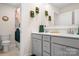 Bathroom with double sinks, modern cabinetry, and decorative wall plants at 4116 Tory Path Rd, Waxhaw, NC 28173