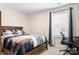 Simple bedroom with wooden bed frame and an office setup at 4116 Tory Path Rd, Waxhaw, NC 28173