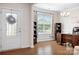 Bright home office with hardwood floors, a large window, and a modern desk and shelving at 4116 Tory Path Rd, Waxhaw, NC 28173
