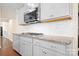 Modern kitchen design showcasing granite countertops, gas range, and sleek gray cabinetry at 4116 Tory Path Rd, Waxhaw, NC 28173