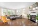 Cozy living room featuring a fireplace, large sectional sofa, and ample natural light at 4116 Tory Path Rd, Waxhaw, NC 28173