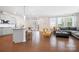 Open-concept living space with modern kitchen, dining area, and comfortable seating area with a grey couch at 4116 Tory Path Rd, Waxhaw, NC 28173