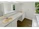 Bright bathroom featuring a large vanity with dual sinks, a jacuzzi tub, and a window for natural light at 424 Mallard Dr, Pineville, NC 28134