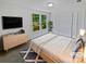 Stylishly staged bedroom with large windows, television and plenty of storage at 424 Mallard Dr, Pineville, NC 28134