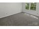 Bright, airy bedroom featuring plush carpet and views of a verdant outdoor area at 424 Mallard Dr, Pineville, NC 28134