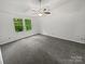 Spacious bedroom with a ceiling fan, large windows, and neutral-colored carpet at 424 Mallard Dr, Pineville, NC 28134