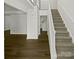 Hallway and staircase to the upper level, with freshly painted walls and hardwood flooring at 424 Mallard Dr, Pineville, NC 28134