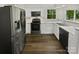 Modern kitchen with stainless steel appliances, white cabinets, and granite countertops at 424 Mallard Dr, Pineville, NC 28134