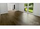 Cozy living area with large window offering natural light and hardwood flooring at 424 Mallard Dr, Pineville, NC 28134