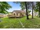 Lush backyard with stone pathway leading to rear exterior of home featuring wooden deck at 5221 Javitz Rd, Charlotte, NC 28216