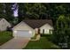 Charming single-story home boasts an attached garage and a well-manicured lawn at 5221 Javitz Rd, Charlotte, NC 28216
