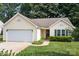 Inviting single-story home with green shutters has an attached garage and walkway at 5221 Javitz Rd, Charlotte, NC 28216