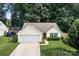 Inviting single-story home featuring well-maintained landscaping and an attached garage at 5221 Javitz Rd, Charlotte, NC 28216