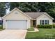 This home has an attached garage, manicured shrubs, and a sidewalk to the front door at 5221 Javitz Rd, Charlotte, NC 28216