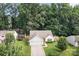Charming single-story home with attached garage, nestled amid lush trees offering privacy in a tranquil neighborhood setting at 5221 Javitz Rd, Charlotte, NC 28216