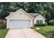 Charming single-story home has a two-car garage and manicured front lawn at 5221 Javitz Rd, Charlotte, NC 28216