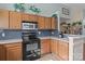 Well-equipped kitchen with oak cabinets, stainless appliances, and a breakfast bar at 5221 Javitz Rd, Charlotte, NC 28216