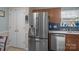 Bright kitchen with stainless steel refrigerator and door to pantry at 5221 Javitz Rd, Charlotte, NC 28216