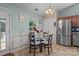 Bright kitchen with stainless steel appliances, tiled floors, and cozy dining area at 5221 Javitz Rd, Charlotte, NC 28216