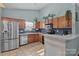 Well-lit kitchen with stainless steel appliances, oak cabinetry and subway tile backsplash at 5221 Javitz Rd, Charlotte, NC 28216