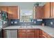 Well-lit kitchen with stainless steel appliances, oak cabinetry and subway tile backsplash at 5221 Javitz Rd, Charlotte, NC 28216