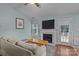 Cozy living room has a fireplace, ceiling fan, and a back patio exit at 5221 Javitz Rd, Charlotte, NC 28216