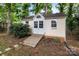Backyard shed with white trim and wooden ramp at 5221 Javitz Rd, Charlotte, NC 28216