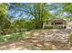 View of house in the back with a large tree and overgrown grass at 524 W Horah St, Salisbury, NC 28144