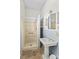 Bathroom featuring a vintage-style pedestal sink, tiled walls, and a stand-up shower at 524 W Horah St, Salisbury, NC 28144