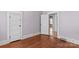Bedroom featuring hardwood floors and neutral walls, with a doorway leading to another room at 524 W Horah St, Salisbury, NC 28144