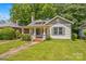 Charming home with inviting curb appeal, a red front door, and lush green lawn at 524 W Horah St, Salisbury, NC 28144