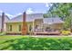 Rear exterior showcasing a patio and well-maintained lawn with mature landscaping at 5610 Monticello Nw Dr, Concord, NC 28027