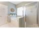 Bright bathroom featuring a large tub, walk-in shower, and white neutral color scheme at 5610 Monticello Nw Dr, Concord, NC 28027