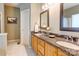 Spacious bathroom featuring double vanity with granite countertops and decorative framed mirrors at 5610 Monticello Nw Dr, Concord, NC 28027