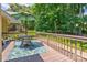 Outdoor deck area with a table, chairs, and a green umbrella for shade at 5610 Monticello Nw Dr, Concord, NC 28027