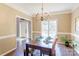 Cozy dining room featuring a wooden table, chandelier, and view of the front door at 5610 Monticello Nw Dr, Concord, NC 28027