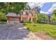 Beautiful two-story brick home featuring an attached garage, lush lawn, and charming curb appeal at 5610 Monticello Nw Dr, Concord, NC 28027