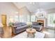 Cozy living room with fireplace, vaulted ceiling, and comfortable sectional sofa at 5610 Monticello Nw Dr, Concord, NC 28027