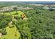 Aerial view of a home nestled in a wooded area, surrounded by lush greenery and neighboring houses at 5635 Highway 55 E Hwy, Clover, SC 29710