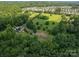 Aerial view of the property shows the home, lawns, landscaping, and nearby homes and open space at 5635 Highway 55 E Hwy, Clover, SC 29710