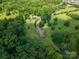 Aerial view showcases a home with a vast lawn, partially surrounded by woods at 5635 Highway 55 E Hwy, Clover, SC 29710