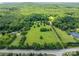 An aerial view reveals the property and its surroundings: lawns, woods, and open land with some roads nearby at 5635 Highway 55 E Hwy, Clover, SC 29710
