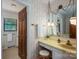 Bathroom featuring retro floral wallpaper, a large vanity with a unique lighting fixture and wood accents at 5635 Highway 55 E Hwy, Clover, SC 29710