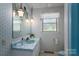 Bathroom with blue fixtures, unique lighting, patterned wallpaper, and a window at 5635 Highway 55 E Hwy, Clover, SC 29710