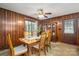 Dining area with wood paneled walls, carpet flooring, and sliding door to the outside at 5635 Highway 55 E Hwy, Clover, SC 29710