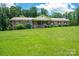 Charming brick home featuring a large front yard with mature trees and welcoming front porch at 5635 Highway 55 E Hwy, Clover, SC 29710