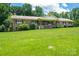 Charming brick home featuring a large front yard with mature trees and welcoming front porch at 5635 Highway 55 E Hwy, Clover, SC 29710