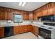 Kitchen with wooden cabinets, updated appliances, tile floors, and bright lighting at 5635 Highway 55 E Hwy, Clover, SC 29710